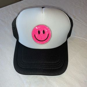 Black smiley face trucker hat